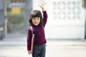 child waving