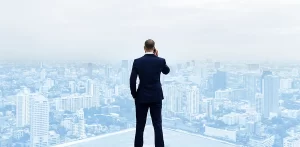 rear view of a businessman talking on the phone on top of a building